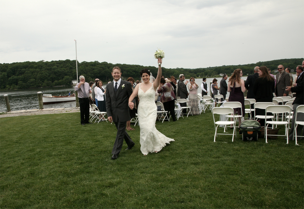 Happy Bride and Groom leaving their wedding ceremony photographed by Atlantic Coast Entertainment